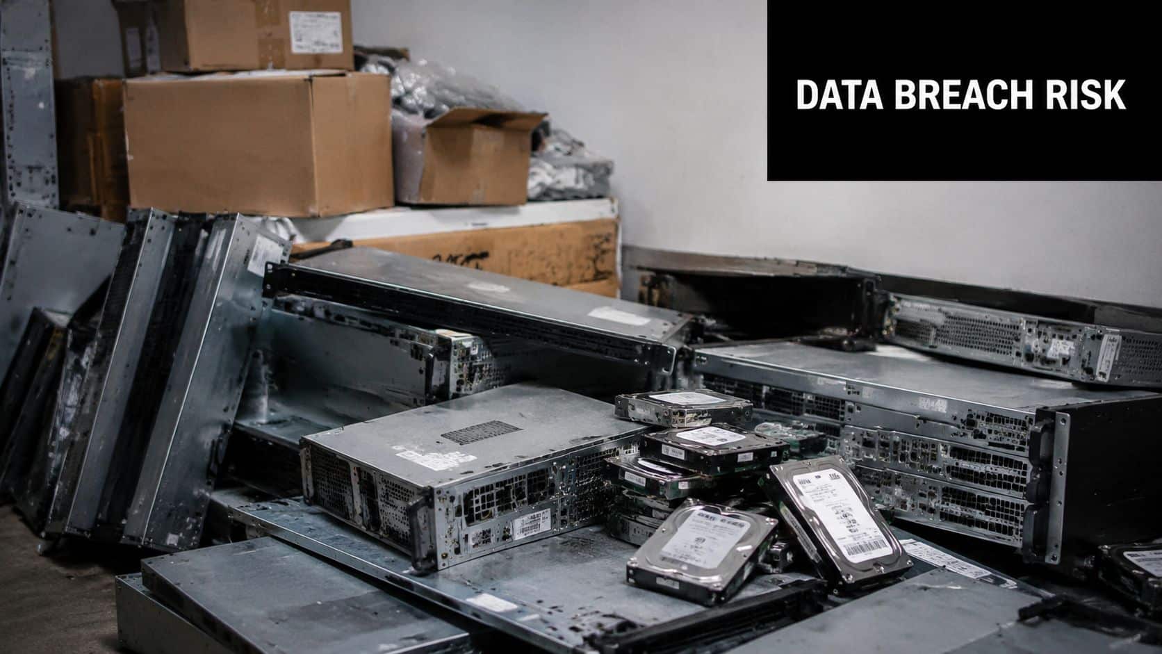 A pile of discarded server hardware and hard drives representing potential data breach risks for companies.